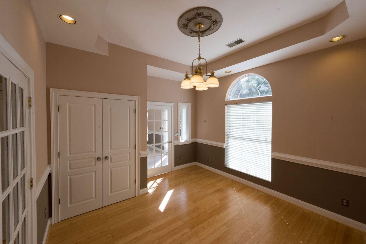Office with chandelier and tray ceiling